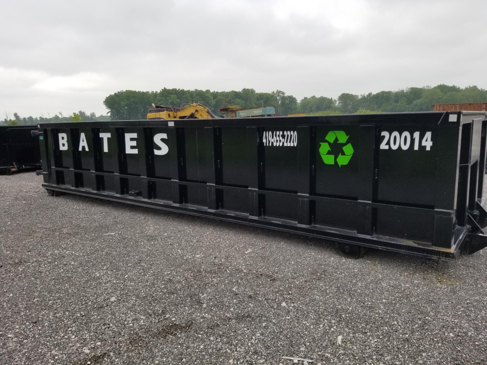 A black dumpster with the name bates on it.